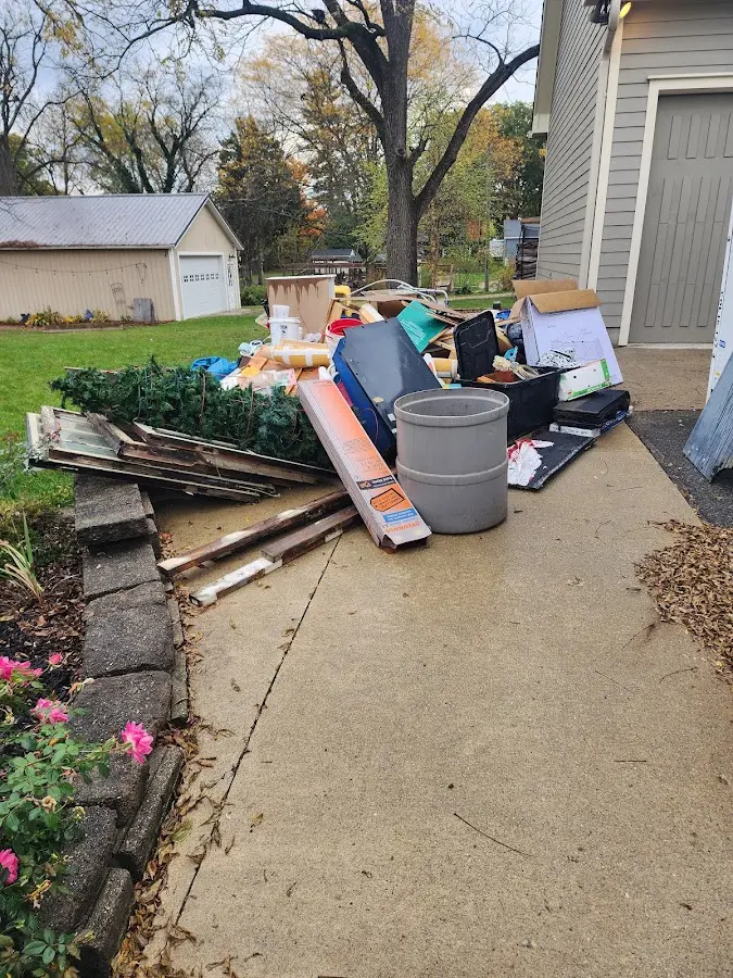 Dumpster being loaded with debris for 12 Yard Dumpster Rental in Columbia
